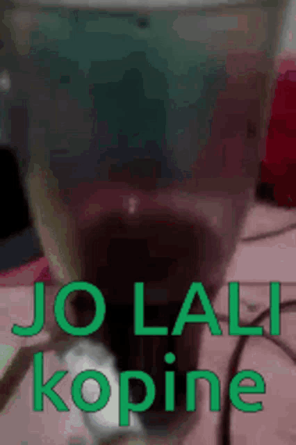 a close up of a glass with the words jo lali kopine on it