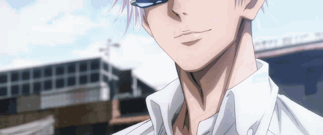 a close up of a person 's face with a white shirt on