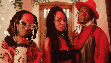 two men and a woman are posing for a picture together