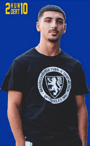 a man wearing a black t-shirt with a lion on it