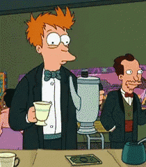 a man in a tuxedo is holding a cup of tea and a blender