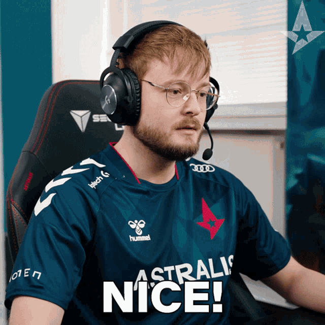 a man wearing headphones and a shirt that says ' astralis nice '