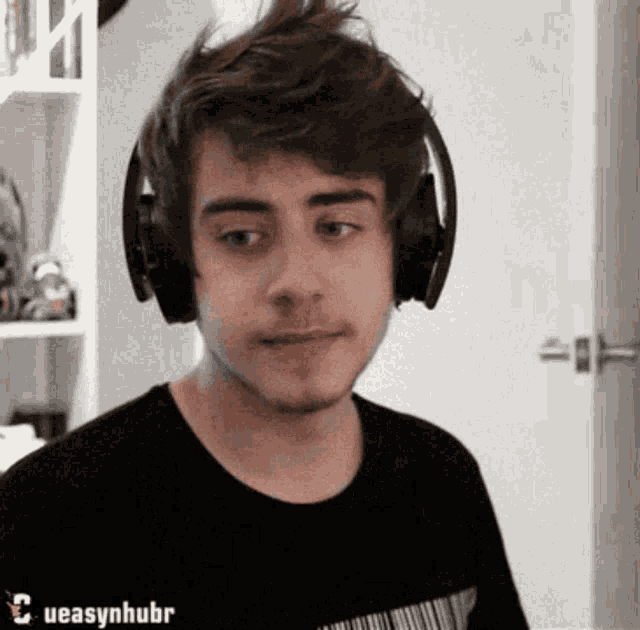 a young man wearing headphones has ueasynhubr written on the bottom of his shirt