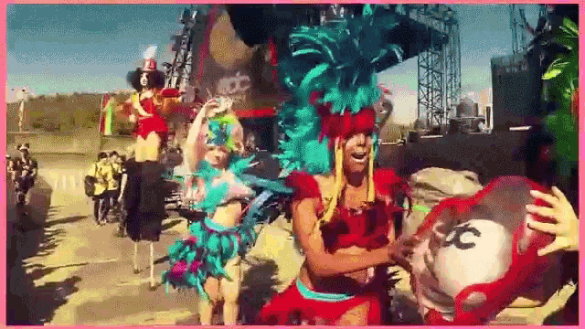 a group of people in colorful costumes are dancing in front of a sign that says ncdc