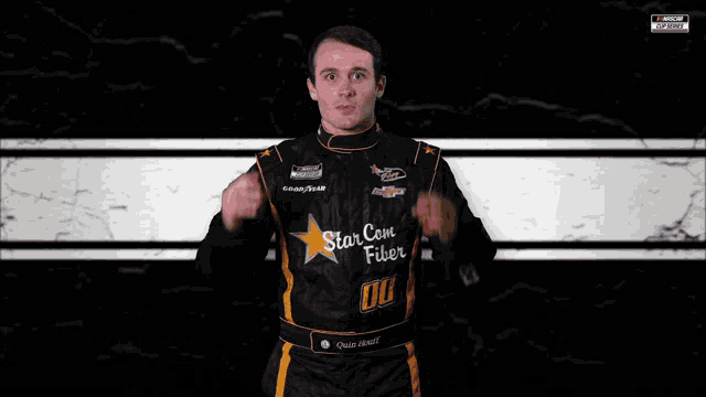 a man wearing a black and orange racing suit with star con fiber on it
