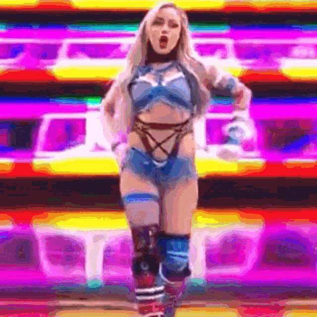 a woman is standing in front of a colorful background .