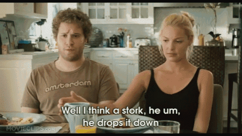 a man and a woman are sitting at a table and the man is wearing an amsterdam shirt