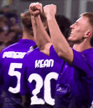 a man in a purple shirt with the number 520 on the back