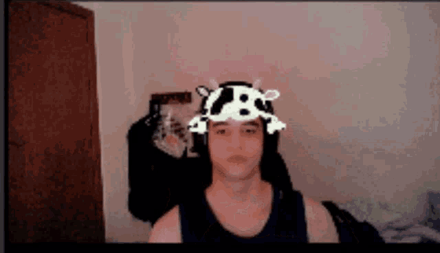 a man wearing a cow hat with skulls on it