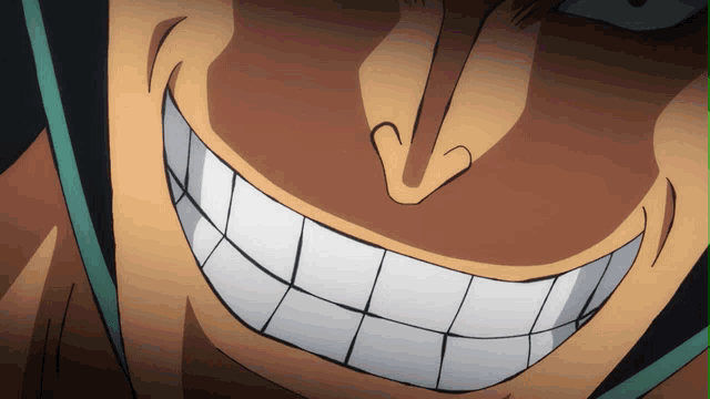a close up of a man 's face with a large smile