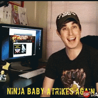 a man sitting in front of a computer with the words ninja baby strikes again