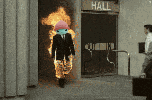 a man with flames coming out of his pants is walking into a building that says hall