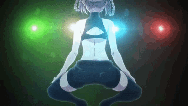 a girl is squatting down in front of a green light