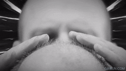 a black and white photo of a man 's face with the website gifrun.com visible
