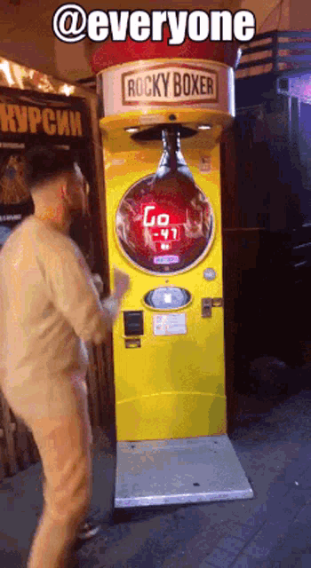 a man is standing in front of a rocky boxer