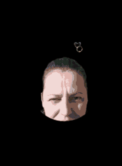 a woman 's face is surrounded by soap bubbles in a black background