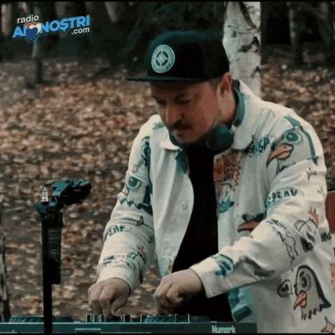 a man wearing a hat and headphones is playing music on a radio a nostri.com website