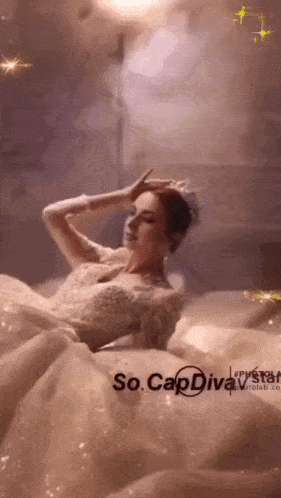 a woman in a wedding dress is laying on a bed with the caption so cap diva