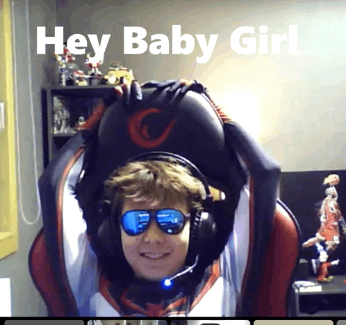 a man wearing headphones and sunglasses is sitting in a chair with the words hey baby girl above him