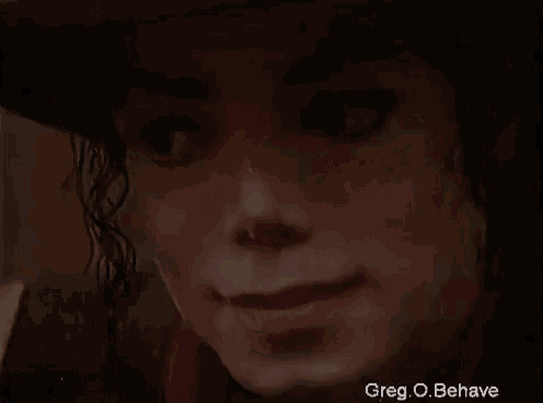 a close up of a person 's face with a hat on and a red scarf around their neck .