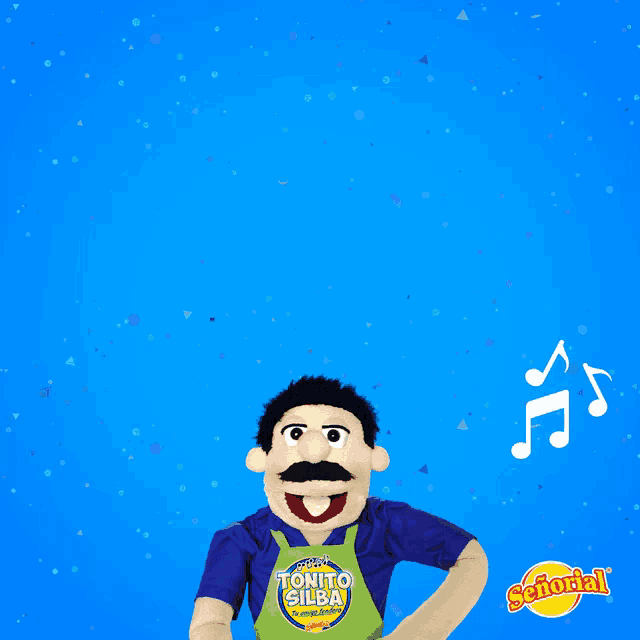 a puppet wearing an apron that says tonito gilba on it