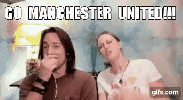a man and a woman are sitting next to each other on a video call and the man is covering his mouth with his hand .