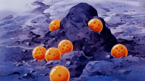a bunch of orange balls with stars on them on a rock