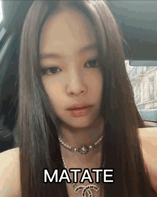 a woman wearing a necklace with the word matate written on it