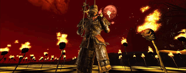 a man in armor stands in front of a field of fire