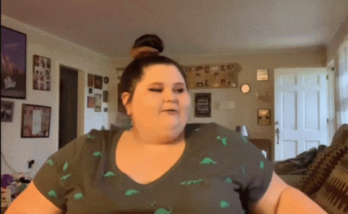 a woman wearing a t-shirt with dinosaurs on it