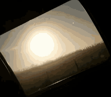 the sun is shining through a window with a fence in the background