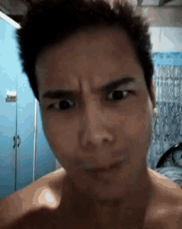 a man without a shirt is making a funny face with his eyes closed