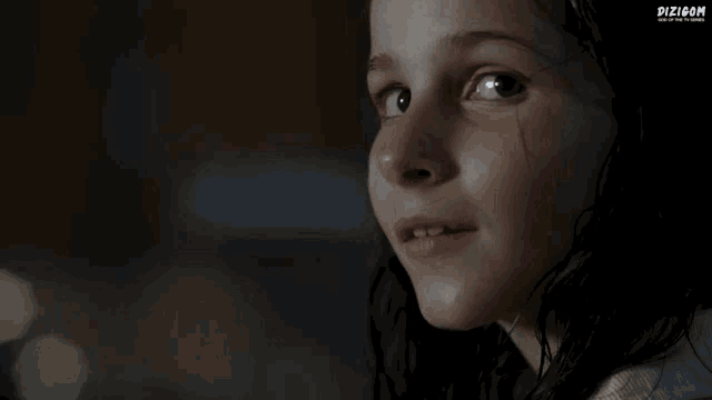 a close up of a girl 's face with a dizicom logo in the corner