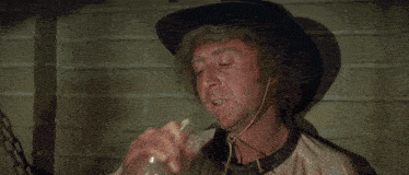 a man in a cowboy hat drinks from a bottle that says ryeberry