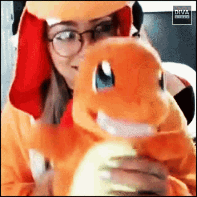 a woman is holding a stuffed animal with diva mobile written on the bottom