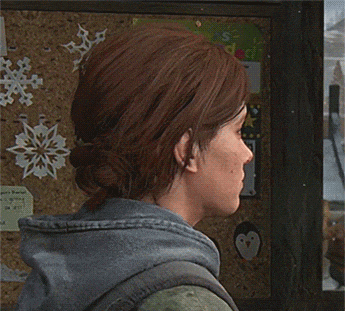 a woman standing in front of a bulletin board with snowflakes on it
