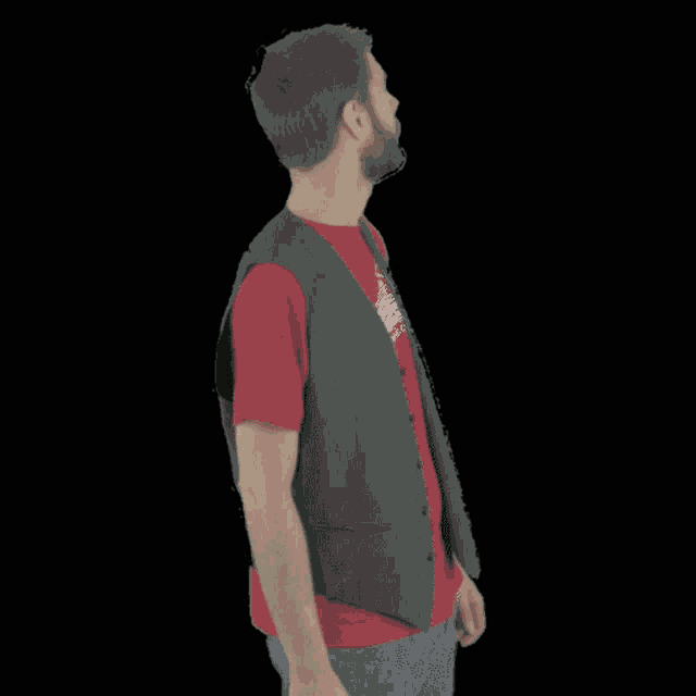 a man wearing a vest and a red t-shirt with the word " cestiram " on the bottom