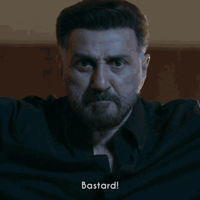 a close up of a man with the word bastard written below him