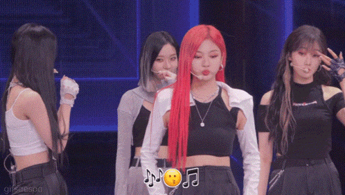 a girl with red hair is standing next to another girl
