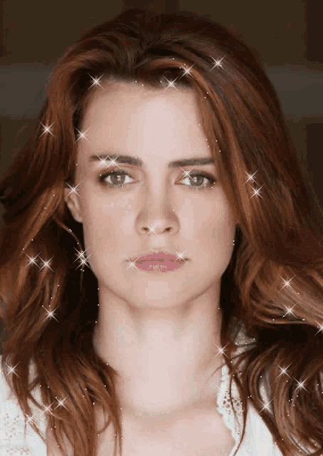 a close up of a woman 's face with sparkles on her face