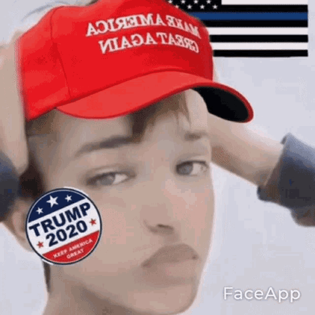 a person wearing a red hat and a sticker that says trump 2020