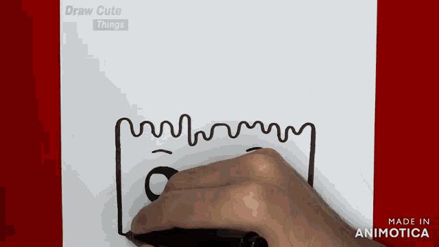 a person is drawing a line with a marker on a piece of paper