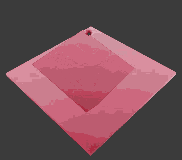 a pink square with a diamond shaped pillow on it