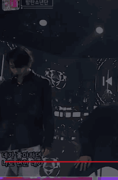 a man in a black shirt and white pants is dancing on a stage