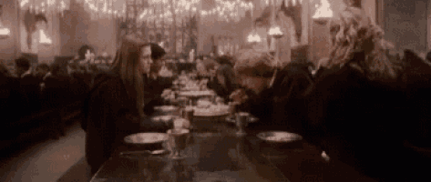 a group of people are sitting at a table in a restaurant .