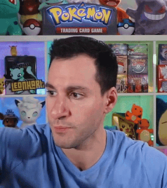 a man in front of a pokemon trading card game