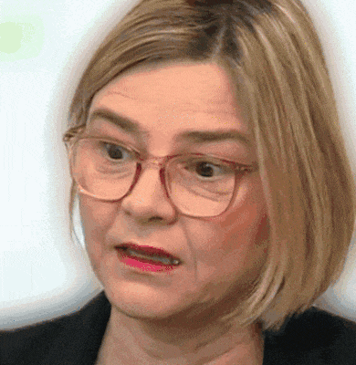 a close up of a woman wearing glasses and a black jacket