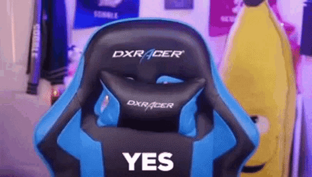 a blue and black dxracer gaming chair is sitting in front of a banana .