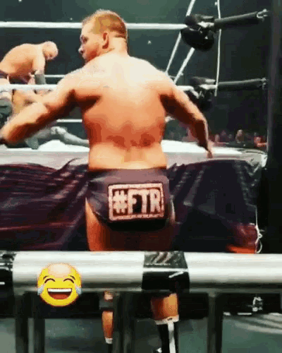 a man in a wrestling ring with a #ftr sticker on his shorts