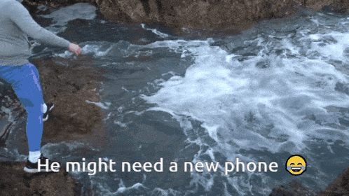 a person standing in a body of water with the words he might need a new phone